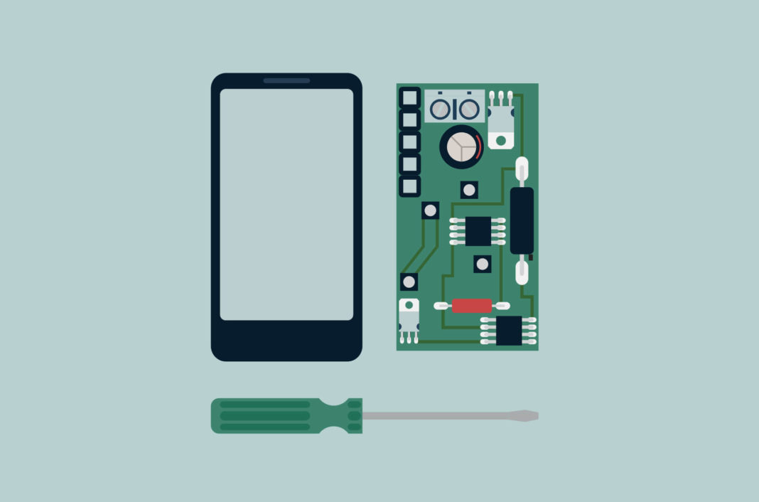 A dismantled phone and screwdriver.