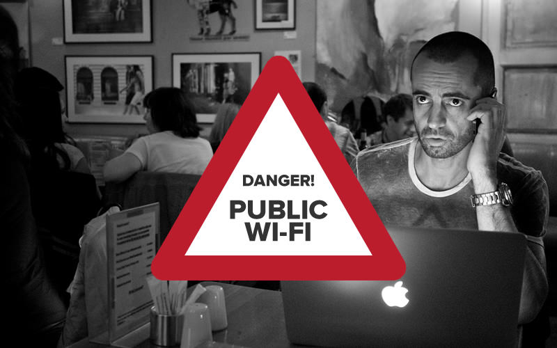 Danger sign. Man on laptop in background.