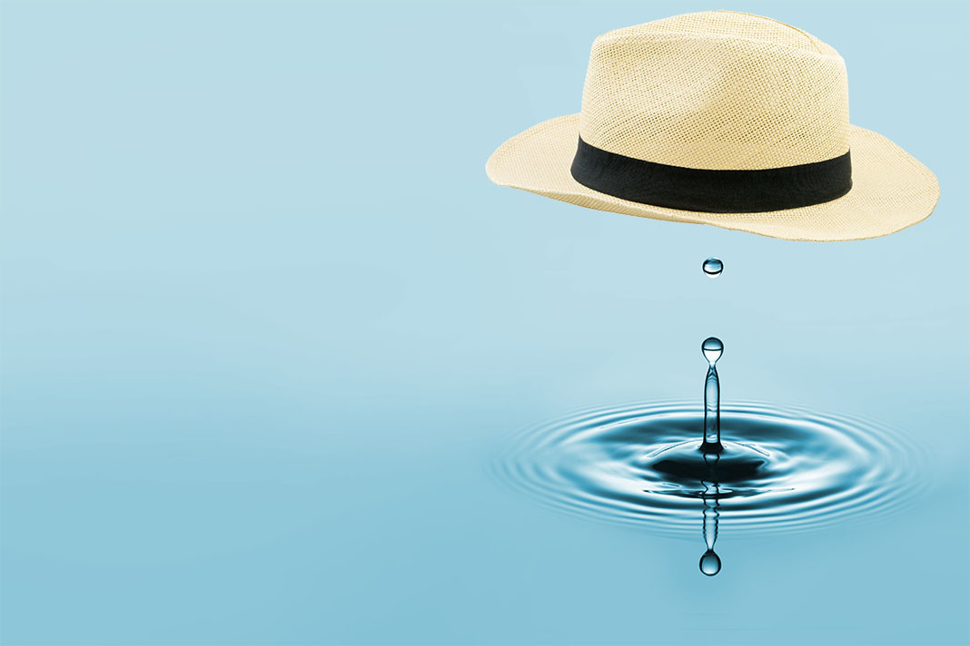 Straw fedora above a drop of water.