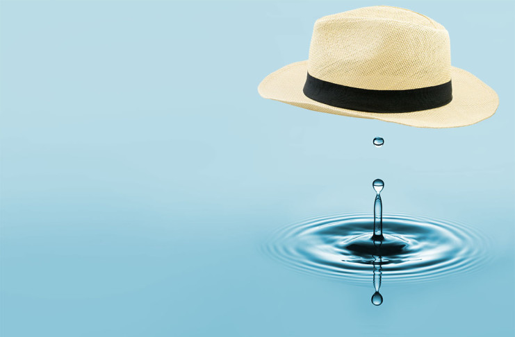 Straw fedora above a drop of water.