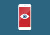 A smartphone screen with an open eye on a red background.