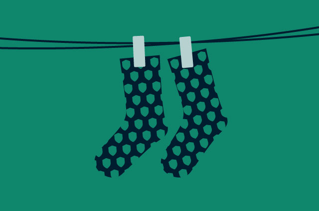 Socks with a shield pattern hanging on a line.