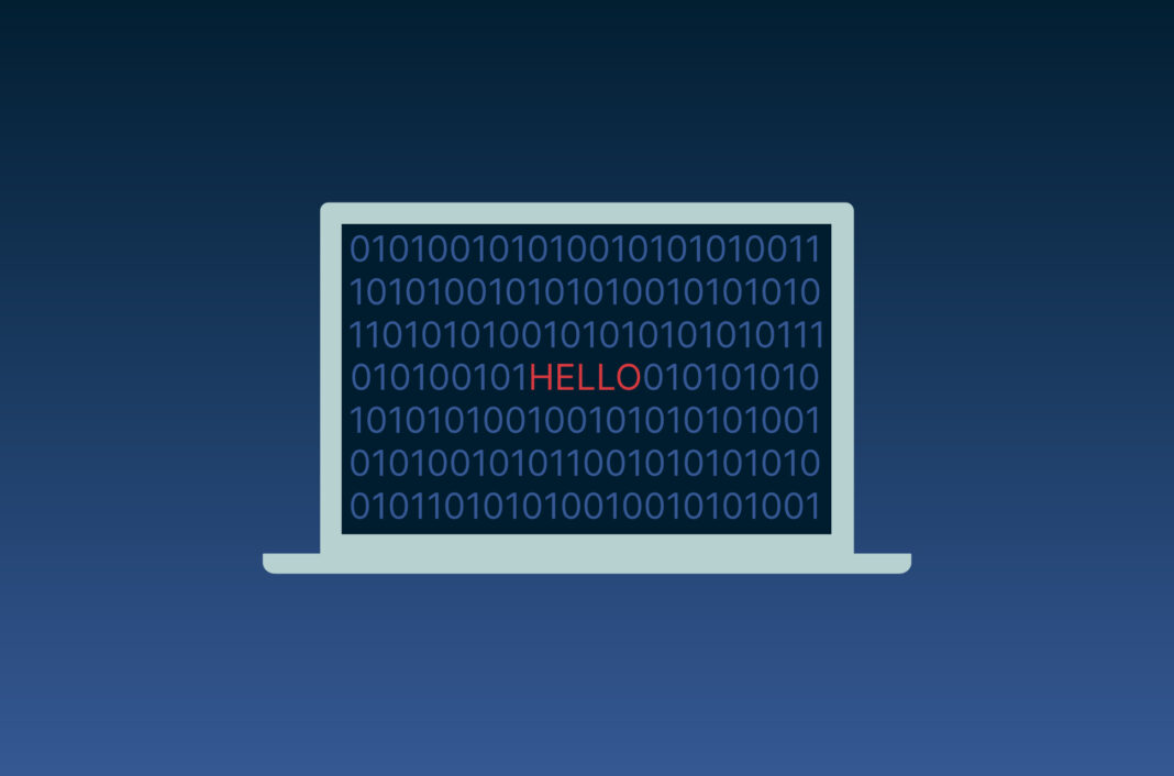 A computer with code and "hello" on its screen.
